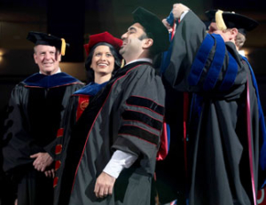 Biomedical engineering Ph.D. student Mohamad Ghosn is robed by Matthew Franchek, professor and chair of mechnical engineering, as University of Houston President Renu Khator and Cullen College of Engineering Dean Joseph Tedesco look on during fall commencement last Friday. Photo by Thomas Shea.