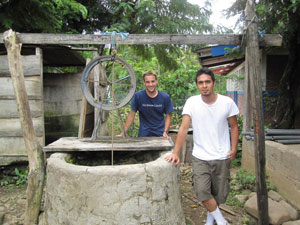 Rhys Forgie (back) and Eric Bustamante, both engineering students with the University of Houston Chapter of Engineers Without Borders, pose in front of a water well in San Antonio, Nicaragua. Photo courtesy of EWB.