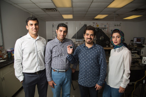 Iceman: Assistant Professor Hadi Ghasemi (far left) is joined by students Seyed Mohammad Sajadi, Peyman Irajizad and Nazanin Farokhnia. Irajizad holds the new magnetic slippery surface.