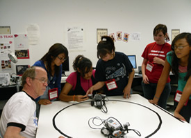 Professor Glover guides campers in building and programming their robot.
