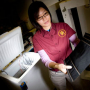 Mechanical engineering graduate student Christiana Chang holds a sheet of carbon nanofiber paper she is embedding in concrete in an effort to create self-heating roads. Photo by Thomas Shea.