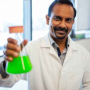  Venkatesh Balan holds a flask of cyanobacteria. Its bright green color is a sign of its ability to convert sunlight into energy. But more intriguing for Balan and his team of researchers is cyanobacteria’s untapped power to capture carbon dioxide from the atmosphere.