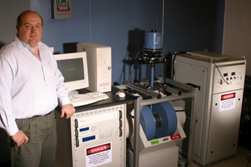 Dmitri Litvinov, associate professor of electrical and computer engineering, with a recent donation of a state-of-the-art LakeShore Vibrating Sample Magnetometer system. Photo by Jeff Shaw.