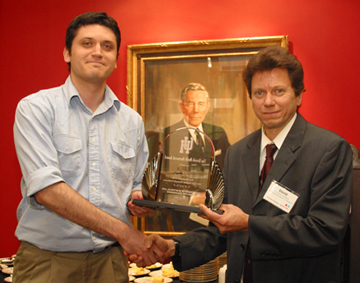 Murat Aydin receives the Urvish Medh Memorial Award from Professor David Jackson at the UH Department of Electrical & Computer Engineering's first Graduate Research Conference. Photo by Jeff Shaw.