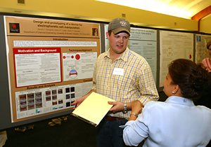 UH chemical engineering senior David Turnquist discusses his research on electrophoretic cell manipulation devices with Mitra Kiani, technology transfer associate in the Office of Intellectual Property Management. Photo by Jeff Shaw.