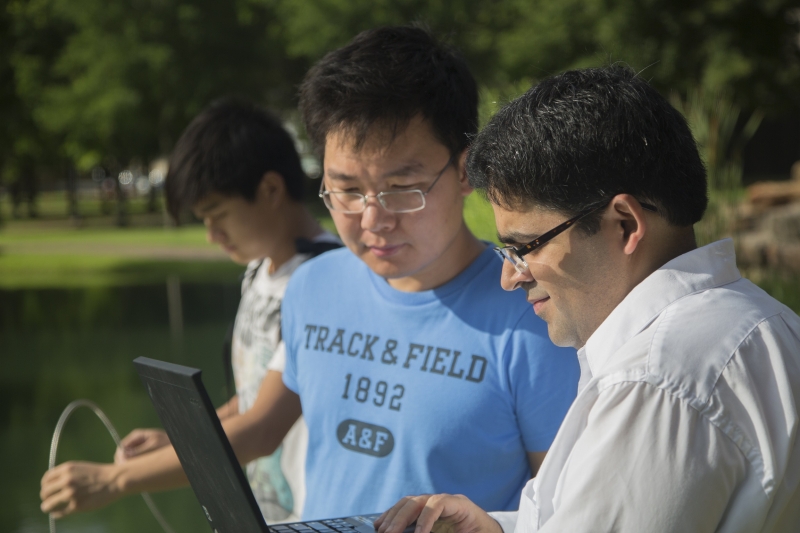 Dr. Saurabh Prasad collects ground data alongside two of his Ph.D. students.