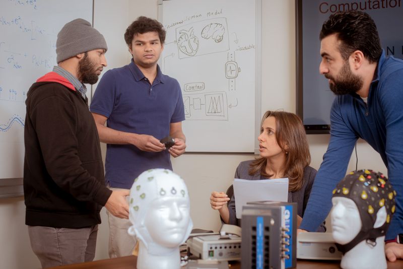 Rafiul Amin (left), Ph.D. graduate Dilranjan Wickramasuriya (left center) and Hamid Fekri Azgomi (right) speak with Rose Faghih (right center) about the MINDWATCH project. Amin and Fekri Azgomi gave a presentation on the research for the National Science Foundation's Cyber-Physical Systems (CPS) Principal Investigators' meetings from June 2 through June 4 in 2021.