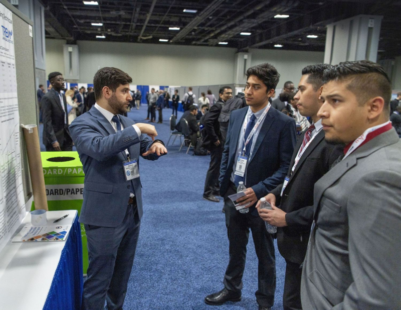 Santiago El Awad (left) speaking at the annual conference for the Dwight David Eisenhower Transportation Fellowship Program. El Awad has earned the fellowship three years in a row.