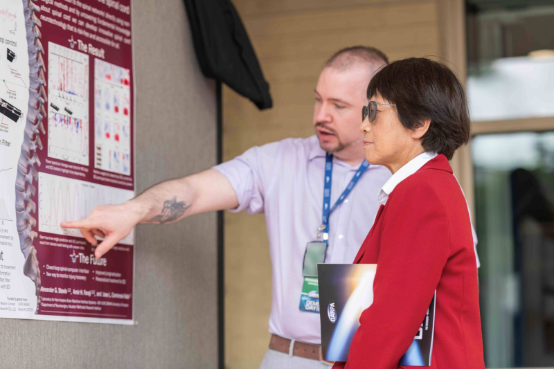 Alex Steele, now a Ph.D. graduate from Cullen, shows his research to Heidi Shyu, the Under Secretary of Defense for Research and Engineering in the U.S. Department of Defense. 