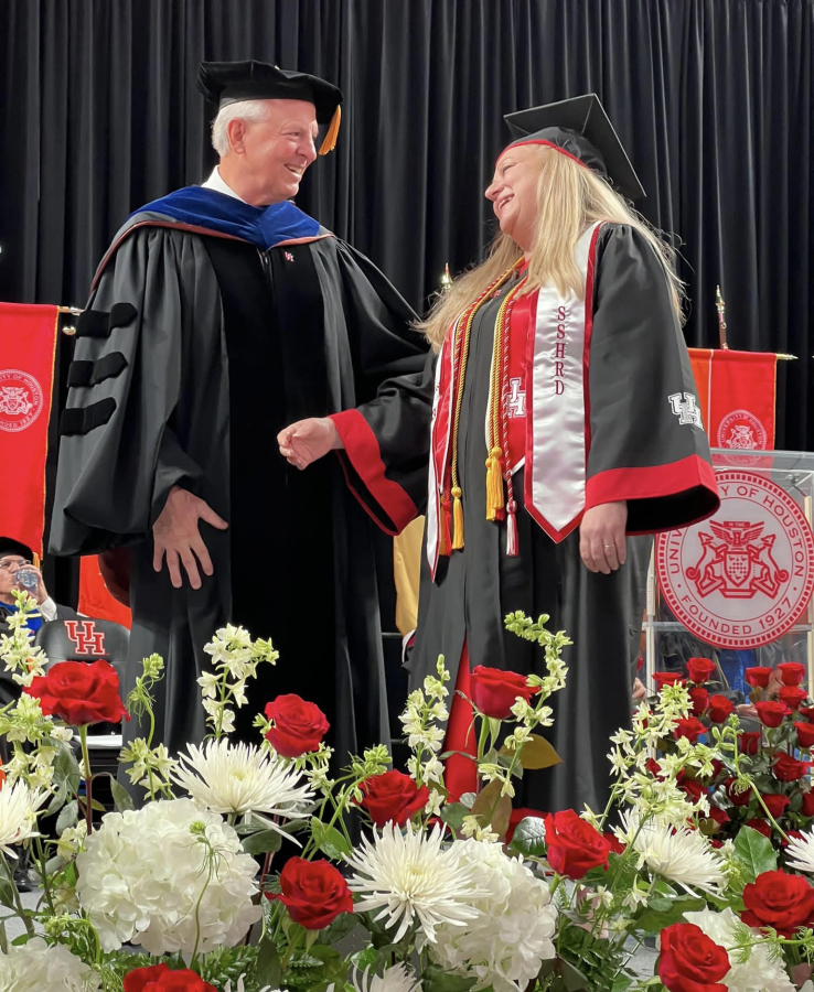Dean Joseph W. Tedesco presents Ann Clark with her degree during a graduation ceremony in May 2023. 