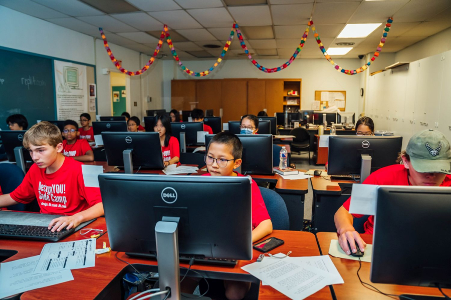 A group of middle school students practice coding during the 2023 DesignYOU! Code Camp.