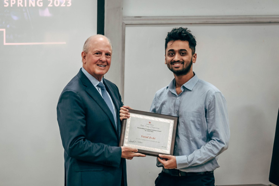 Dean Joseph W. Tedesco presents Varad Joshi, teaching assistant in Chemical and Biomolecular Engineering, with a Teaching Excellence Award.