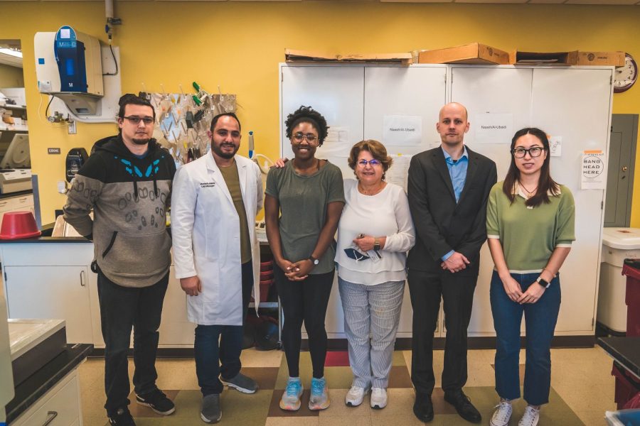 Several of the researchers and professors in the Naash lab pose for a photo. 