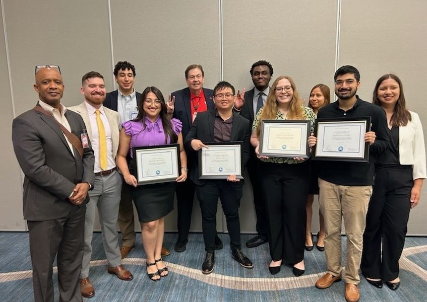 Pictured holding certificates in the front row of the photo are the four winners (L to R): Jenifer Mendoza, Nhan Ho, Emilee Eidlebach, and Horyrah Uddin.