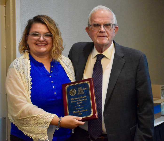 Emeritus Professor of Digital Media and prior Hartman/Dennis Service to Education Awardee Jerry Waite (right) presents the 2024 award to Alters (left).