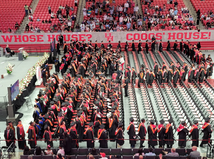 Students start to fill their seats at the graduate commencement ceremony. 