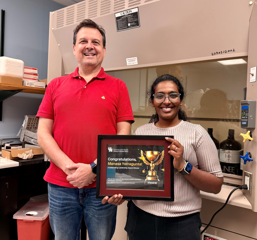 Yerragunta, holding her award certificate, stands with her advisor Peter Velikov.