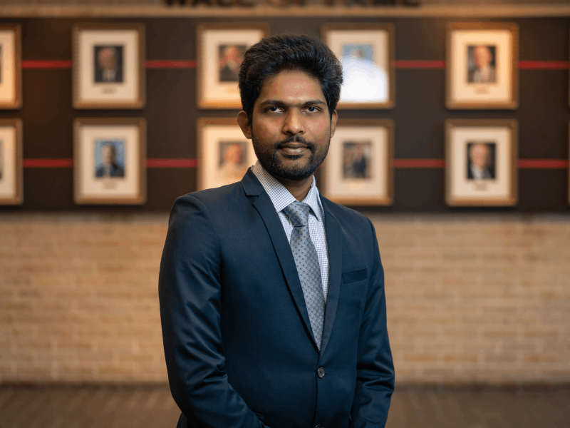 Sai Bhargava Althurthi has been recognized with the IEEE Outstanding Paper Award for the IEEE Journal of Emerging and Selected Topics in Industrial Electronics for his recent paper, “A Novel Ultrawide Output Range DC–DC Converter for EV Fast Charging.” Sai Bhargava Althurthi, wearing a dark blue suit and lighter blue shirt, stands in front of a wall of portraits. He has dark hair and a short, dark beard.