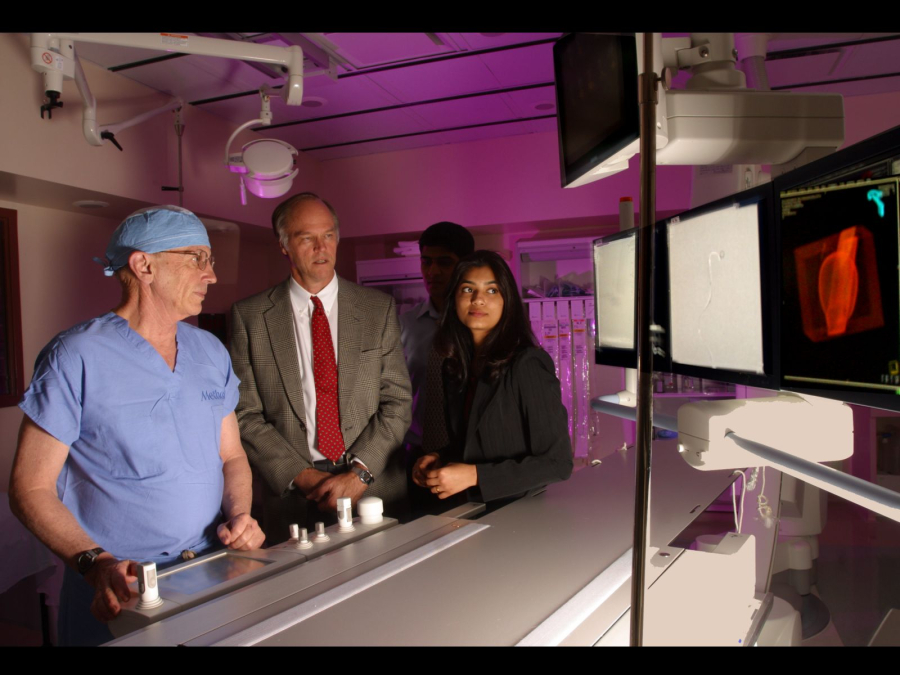 Ralph Metcalfe (center) reviews data on a patient in 2006 with Dr. Charles Strother (left) and Aishwarya Mantha (right).