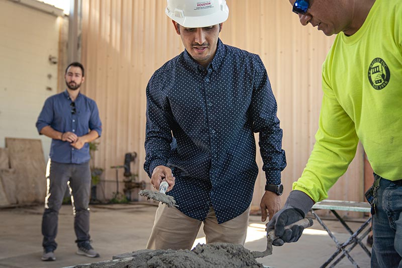 Dimitrios Kalliontzis oversees a graduate student working on Masonry Day, a hands-on day of construction work.