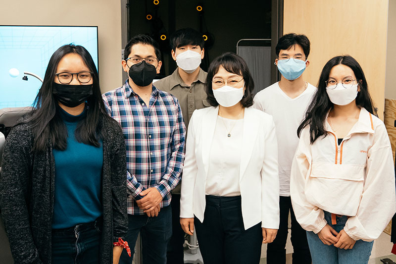 Jinsook Roh (above center) poses with student researchers in her lab.