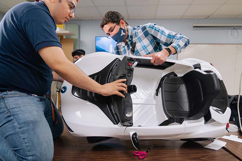 Rogelio Castilla and Omar Nofal determine where to make structural changes to the car body.