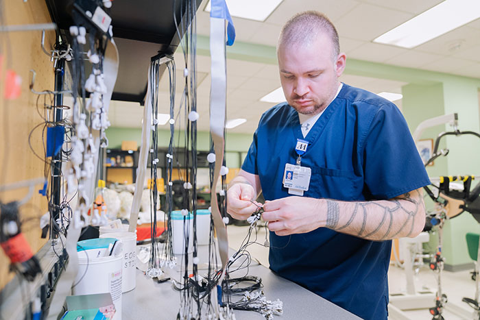 Ph.D. student Alex Steele sorts through a variety of surface EMG sensors in the non-invasive brain-machine interface lab headed by professor Jose Luis Contreras-Vidal.