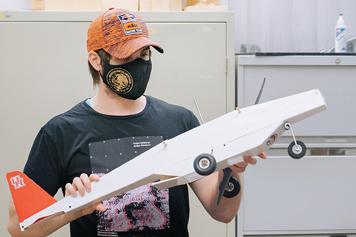 Chief engineer Andre Jimerson holds an example of a previous year's UAV.