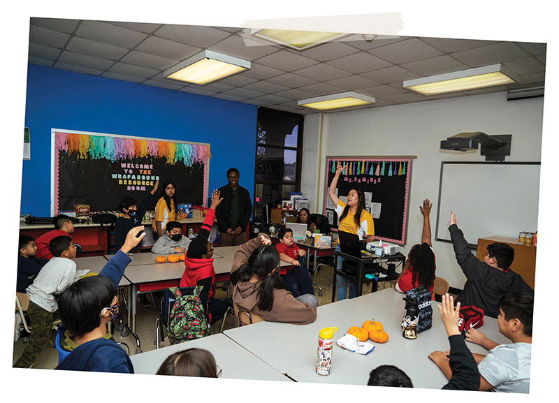 Three UH student volunteers [background, left to right – Alejandra Sanchez, Omar Sanchez and Nghi Lam] lead a group of young minds at Cage Elementary School through a discussion about the science they learned the previous week. For this session, Lam served as the main facilitator.