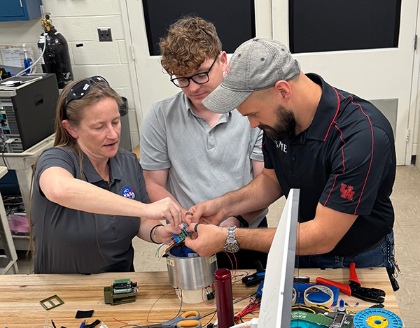 From left to right: Chairty Golleher, Cory Crow and David (Ben) Whaley working in the NASA MSFC Electrostatic Levitation Lab.