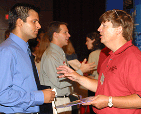 Pranav Khanna, a research assistant in civil engineering, talks with Stan Weber of Chevron-Phillips at the 2003 NSBE Career Fair. Photo by Jeff Shaw.