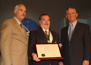 UH Mechanical Engineering Professor Stanley Kleis receives the Public Service Medal from William F. Readdy (left), associate administrator of the space operations mission directorate, and Johnson Space Center Director Gen. Jefferson D. Howell Jr. Photo by Jeff Shaw.