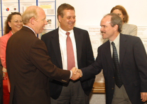 Houston Mayor Bill White is greeted by Michael Harold, professor and chair of the UH Department of Chemical Engineering and the principal investigator on the air quality project, to the UH Diesel Vehicle Research and Testing Facility, which had it's official ribbon-cutting ceremony June 28. Also pictured are (left) Pamela Berger, director of the Mayor’s Office of Environmental Policy, and Arthur Vailas (center), UH vice president for research and intellectual property management. Photo by Jeff Shaw.