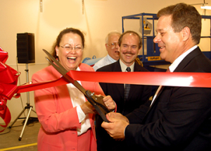 Pamela Berger, director of the Mayor’s Office of Environmental Policy, and Arthur Vailas, UH vice president for research and intellectual property management, cut the ribbon to the UH Diesel Vehicle Research and Testing Facility. Also pictured are Mickey Rooks, UH adjunct chemical engineering professor and director of the facility, and Michael Harold, professor and chair of the UH Department of Chemical Engineering and the principal investigator on the air quality project. Photo by Jeff Shaw.