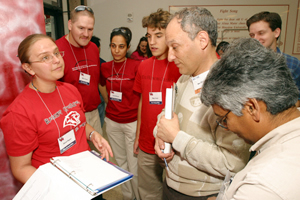 Chemical engineering senior Carol Stojan discusses her team's Chem-E-Car competition entry with judges Lou Diamond, P.E. and Kishore Mohanty, UH professor of chemical engineering. Team members include Mike Kristoff, UH senior math major, and chemical engineering students Loda El-Khalil, senior, and Rhys Forgie, freshman. Photo by Jeff Shaw.