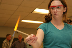 A local teacher tries a science experiment at the Materials Camp—Teachers, hosted by the college June 26-30. Photo by Mark Lacy.