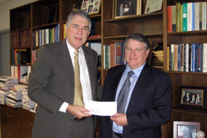 John Duty, executive vice president of Bechtel, Inc., presents Dean Flumerfelt with a check for scholarship support on behalf of the Bechtel Group Foundation.