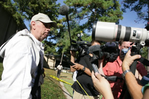 Local bee expert Mike Knuckey speaks to a swarm of regional news outlets following the extraction of the bee hive from Engineering Building 1 at UH. Photo by Mark Lacy.