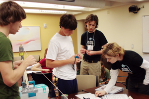 Dr. Julie Trenor, director of undegraduate recruitment and retention at the Cullen College of Engineering, along with mechanical engineering sophomore, Michael Fernandez, help two prospective engineering students with a project during the "Extreme Engineering" course held during Scholars Weekend. Photo courtesy of Engineering Recruitment.