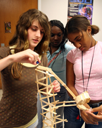 Three MESET Camp participants construct a roller coaster as part of a design challenge to learn basic engineering principals. Photo courtesy of Dr. Kathy Zerda.