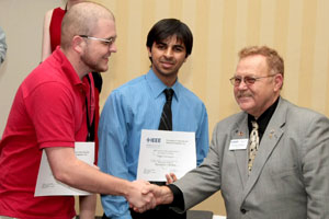 Engineering seniors John Hemmick and Osaid Shamsi receive a first place award in the Region 5 IEEE Technical, Professional and Student Conference regional circuit design competition. Photo by Tom Shea.