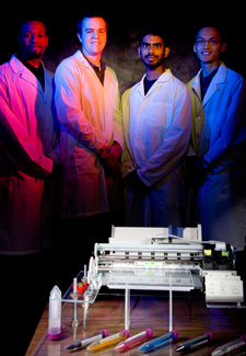 Valor Thomas, Corey Hryc, Shaun Khan and James Liu show off their cell printer, a device designed to help scientists mimic conditions in the body more cheaply.Photo by Thomas Shea.