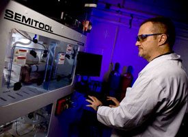 Stanko Brankovic, an assistant professor of electrical and computer engineering, shows off his new Raider M system. A top of the line machine, a grant from its creator, Semitool Inc., earned it a place in his lab. Photo by Thomas Shea.