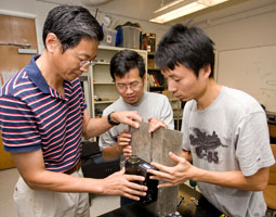 Professor Richard Liu (left) works with graduate students Yu Cai and Yinan Xing on the vehicle-mounted laser device developed in the Cullen College's Subsurface Sensing Lab. Photo by Thomas Shea