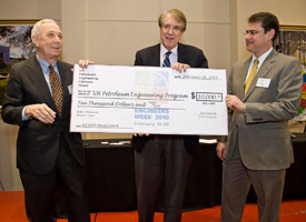 Raymond Flumerfelt, director of the petroleum engineering program, is presented with a check from the college's Petroleum Engineering Advisory Board. Photo by Jeff Fantich.