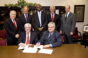 UH Cullen College of Engineering Dean Joseph Tedesco, and Venkat "Selva" Selvamanickam, M.D. Anderson Chair Professor of Mechanical Engineering, sign two license agreements with SuperPower. Photo by Thomas Shea.