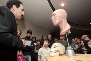 Ali Kamrani, associate professor of industrial engineering at UH, talks to students with The Friends School about the process he used to create replica skulls of three buffalo soldiers on a recent visit to the February museum exhibit. Photo by Thomas Shea.