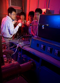 Assistant Research Professor Qingkai Yu working in the lab with electrical and computer engineering graduate students Zhihua Su and Wei Wu and postdoctoral researcher Zhihong Liu. Photo by Thomas Shea. 