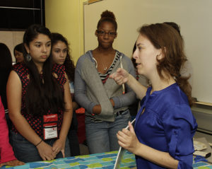 Assistant professor Gila Stein teaches GRADE campers about plastics in the chemical engineering lab. 