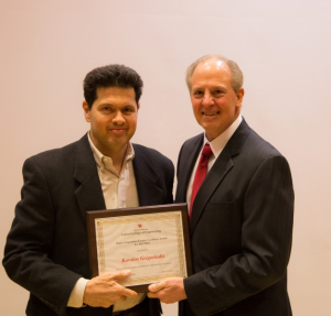 Grigoriadis Accepts Award From Dean Tedesco